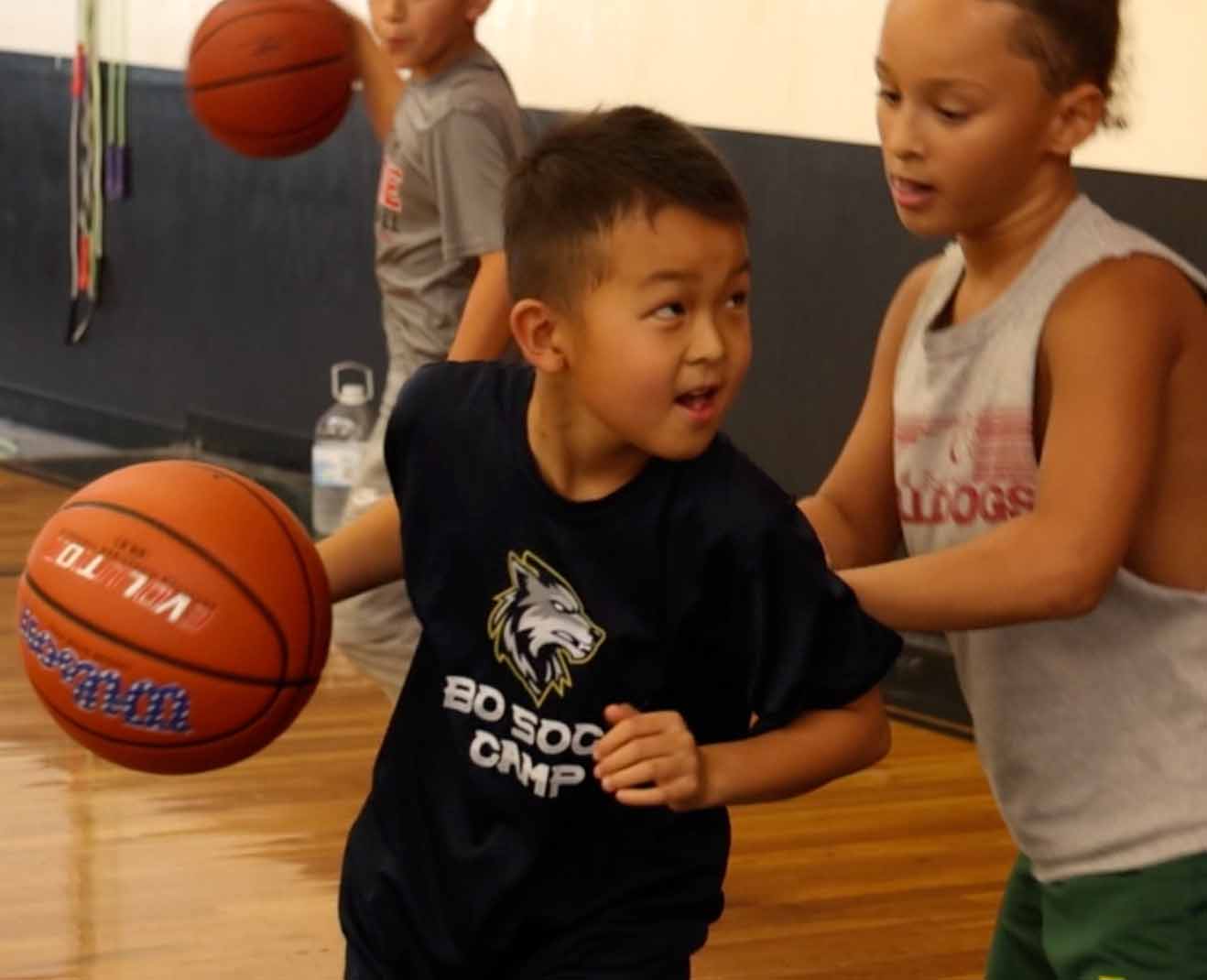 Young player working a dribbling drill at camp